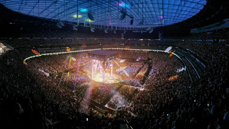Wide aerial view of Allegiant Stadium during a live event. Full house, stage setup visible. Strong hero background for venue or sports content.