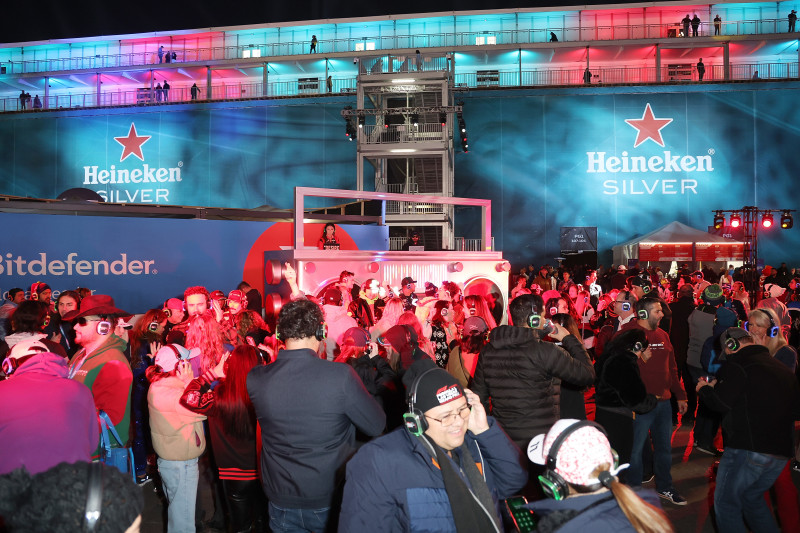 Silent Disco Interactive entertainment zone freatured vibrant lighting and silent-disco headsets.