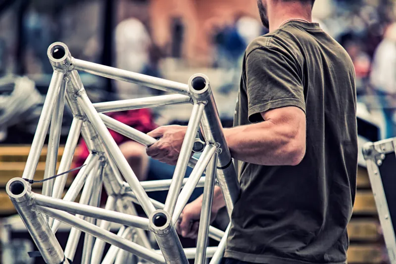 crew worker carrying scaffold