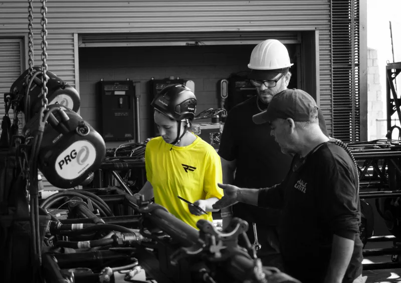 An image of crew building light rigging for an event